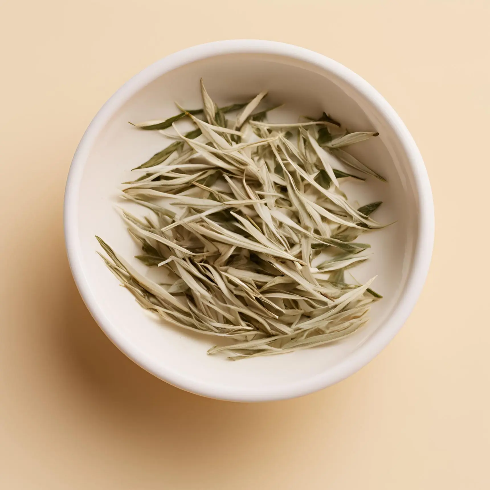 Loose white tea leaves in a bowl, the Moody Teas white tea category